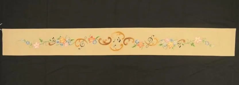 Embroidered piano cover after conservation treatment